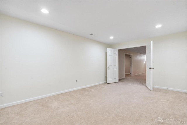 empty room with recessed lighting, baseboards, and light carpet