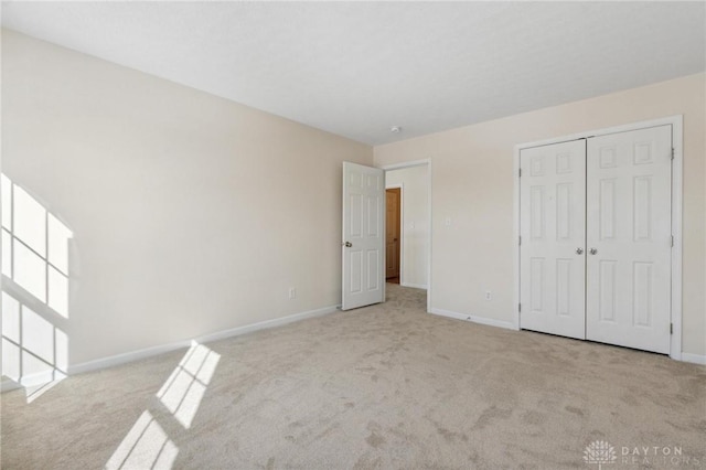 unfurnished bedroom with carpet flooring and baseboards