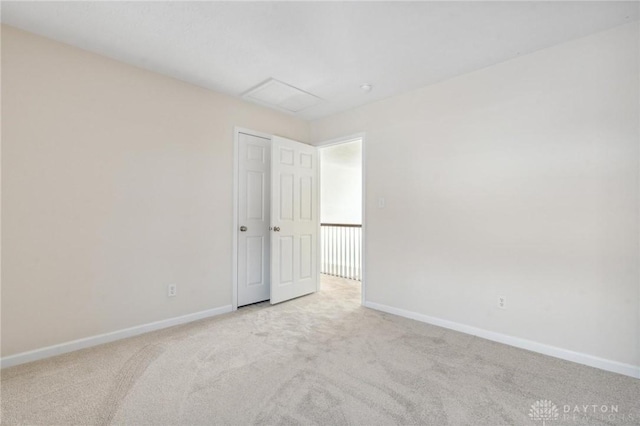 spare room featuring baseboards and carpet flooring