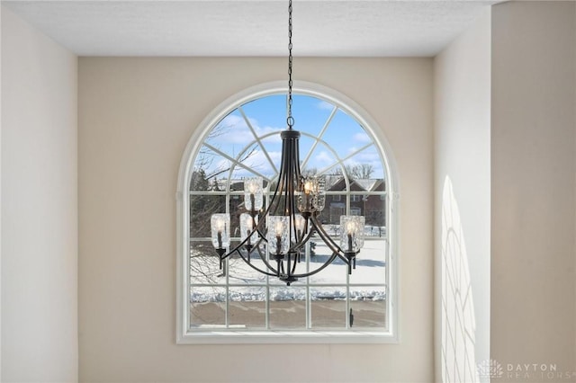 interior details with a textured ceiling and an inviting chandelier