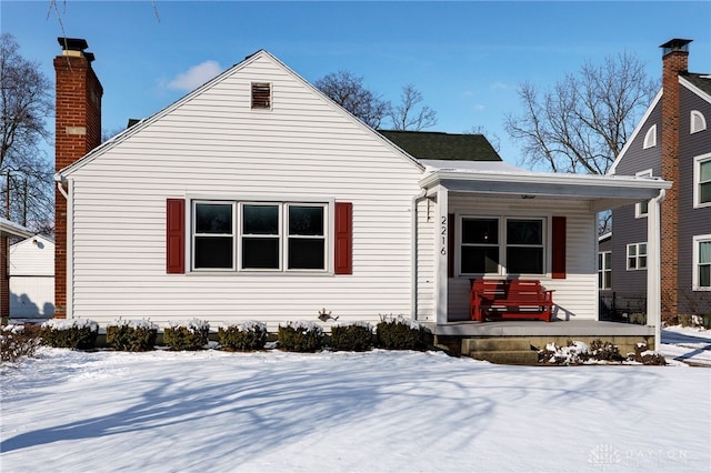 view of front of property with a chimney and a porch