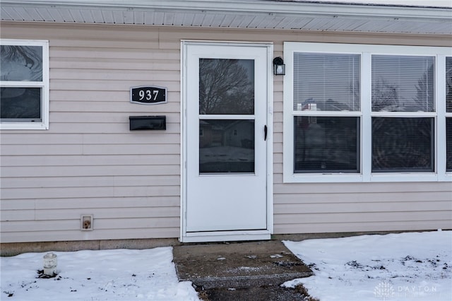 view of snow covered property entrance