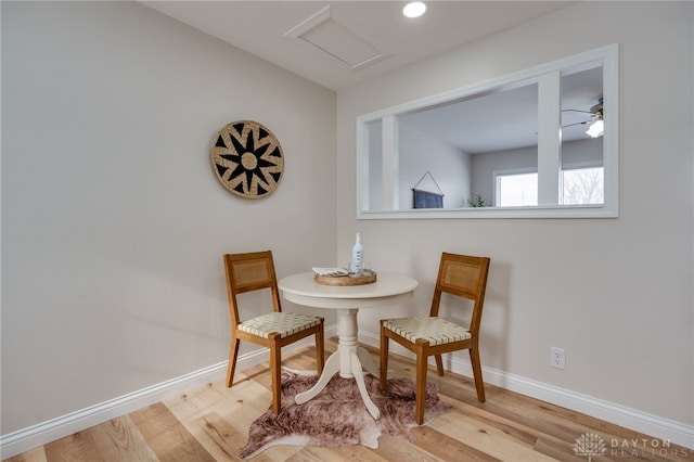 living area featuring recessed lighting, light wood-type flooring, attic access, and baseboards