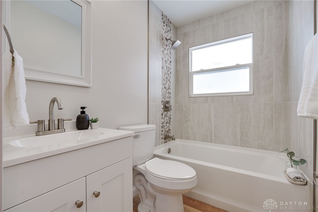 bathroom with shower / bathing tub combination, vanity, and toilet