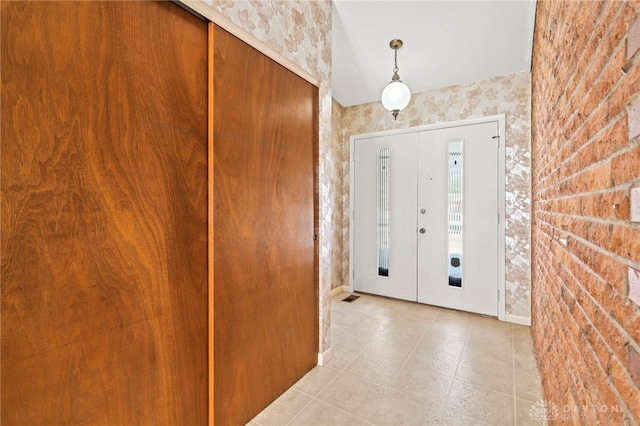 entrance foyer with brick wall