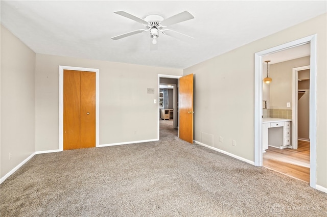 unfurnished bedroom featuring carpet and baseboards