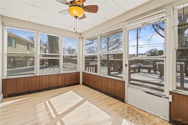 sunroom / solarium with a ceiling fan