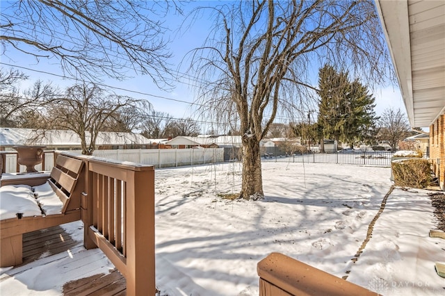 yard layered in snow featuring fence