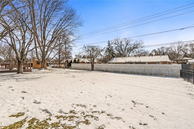 yard layered in snow with fence