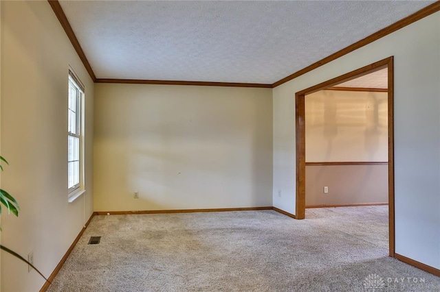 unfurnished room with light carpet, plenty of natural light, visible vents, and a textured ceiling