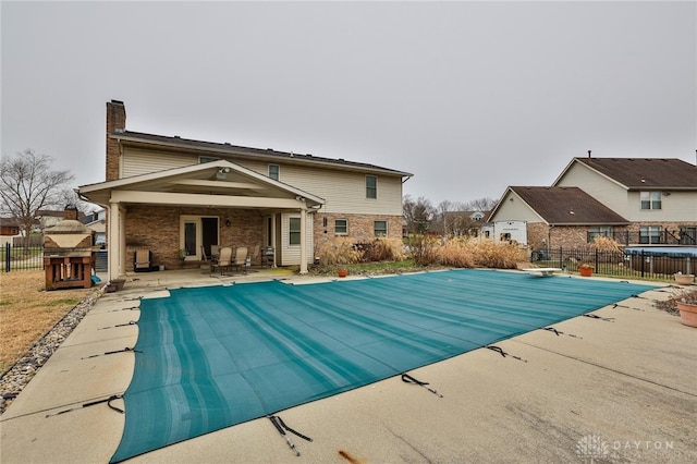 view of swimming pool featuring a fenced in pool, a patio area, and fence