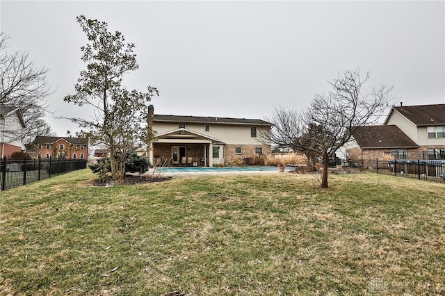 rear view of house featuring a yard, brick siding, a patio, and a fenced backyard