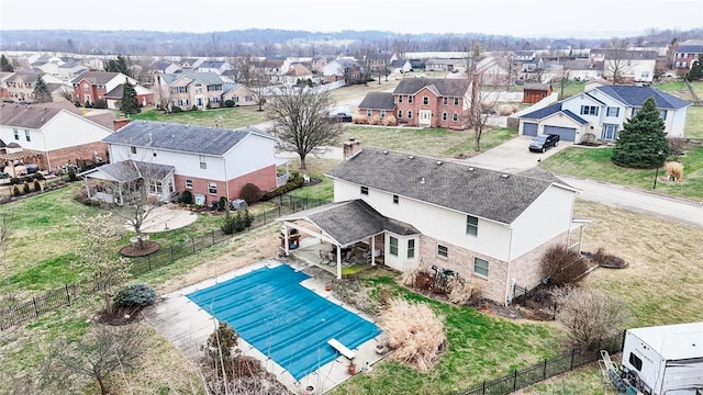 view of swimming pool featuring a diving board, a fenced backyard, a residential view, and a fenced in pool