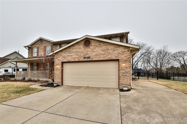 traditional home featuring driveway, a garage, fence, a porch, and brick siding