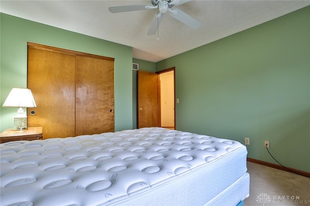 bedroom featuring ceiling fan, carpet floors, a closet, and baseboards