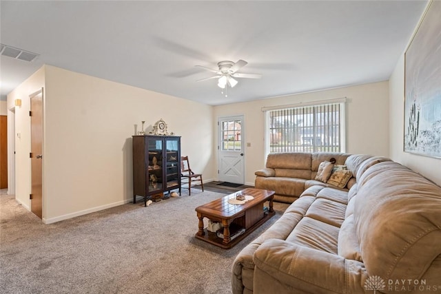 living room featuring baseboards, carpet, visible vents, and a ceiling fan