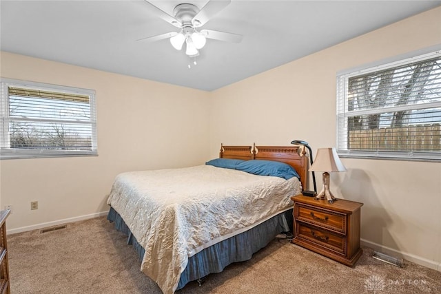 bedroom featuring a ceiling fan, carpet flooring, visible vents, and baseboards