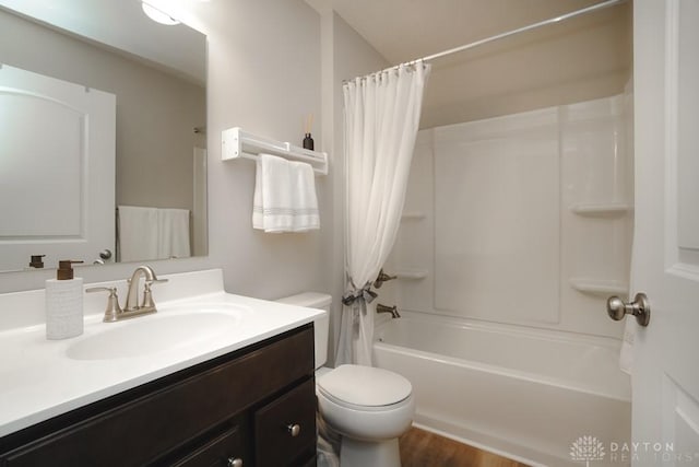 full bathroom featuring wood finished floors, vanity, toilet, and shower / tub combo with curtain