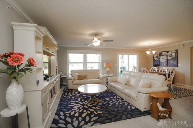 living area with crown molding and a healthy amount of sunlight