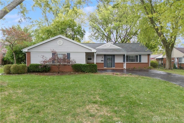 ranch-style home featuring driveway, a front lawn, and brick siding