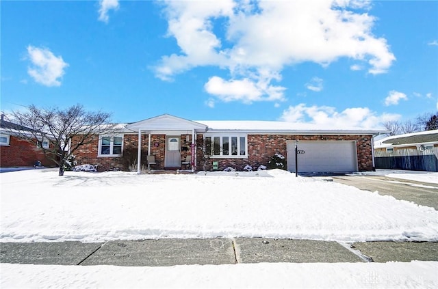 single story home featuring an attached garage and brick siding