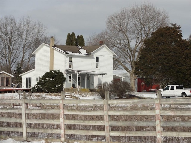 view of front of house featuring fence