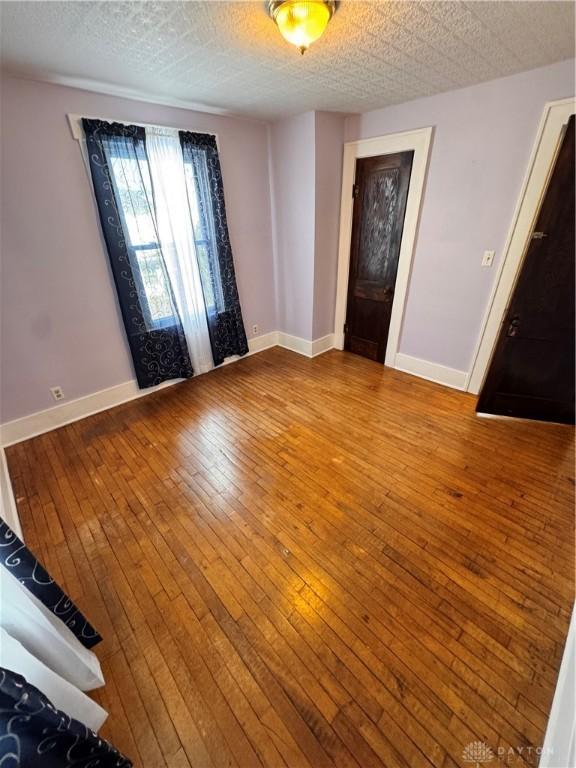 230 New Columbia Blvd, Sidney, OH 45365 - interior space with a textured ceiling, wood finished floors, and baseboards