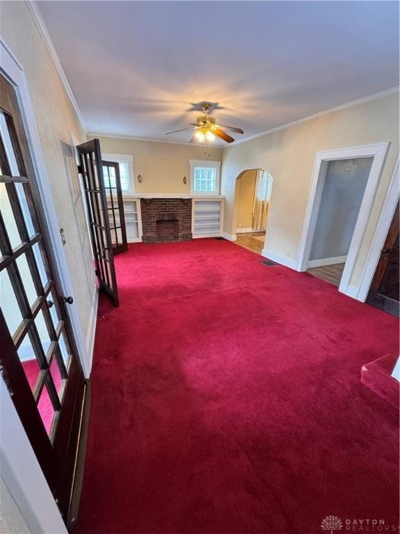 230 New Columbia Blvd, Sidney, OH 45365 - unfurnished living room featuring ceiling fan, carpet floors, a fireplace, and crown molding
