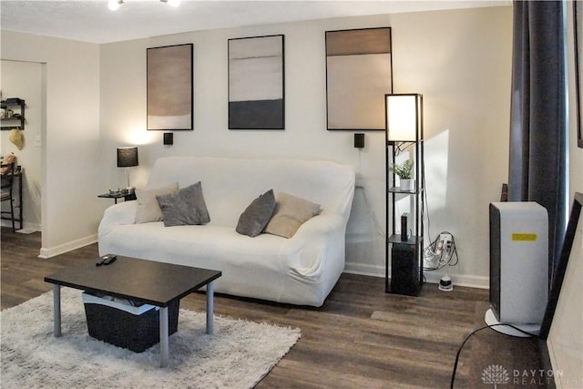 living room featuring baseboards and dark wood finished floors