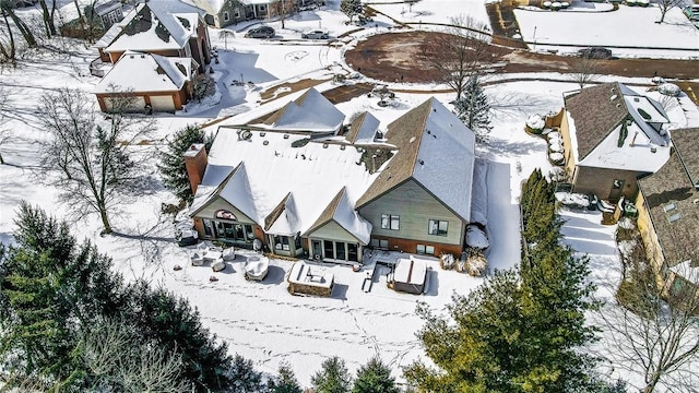 snowy aerial view featuring a residential view