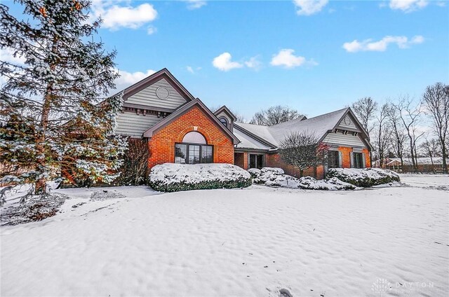 view of front of home featuring a garage and brick siding