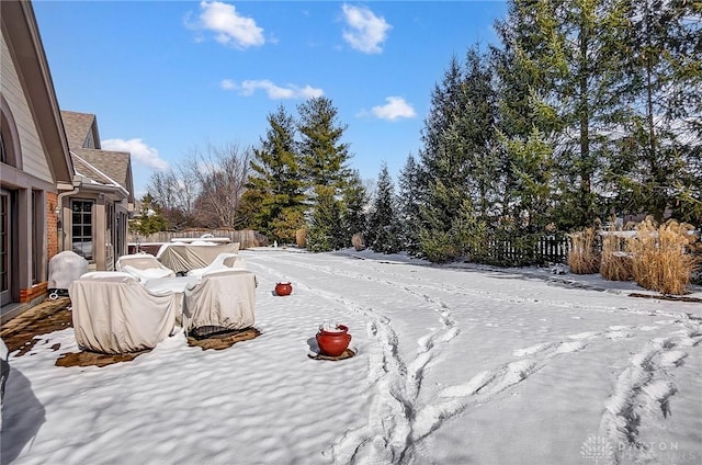 snowy yard with fence