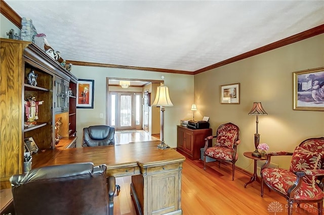 office space with light wood-style floors, ornamental molding, and baseboards