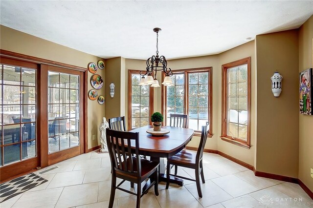 dining area with a chandelier, light tile patterned floors, visible vents, and baseboards