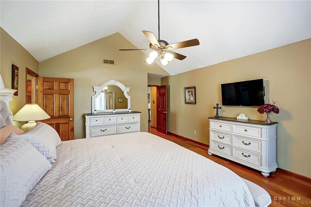 bedroom featuring ceiling fan, visible vents, baseboards, vaulted ceiling, and dark wood-style floors