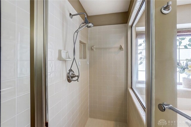 full bath featuring a tile shower