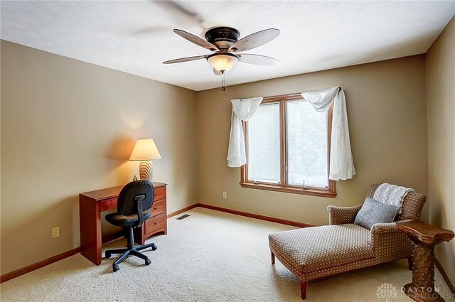 office with a ceiling fan, light carpet, visible vents, and baseboards