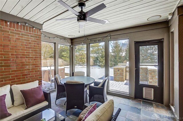 sunroom / solarium featuring wooden ceiling and ceiling fan