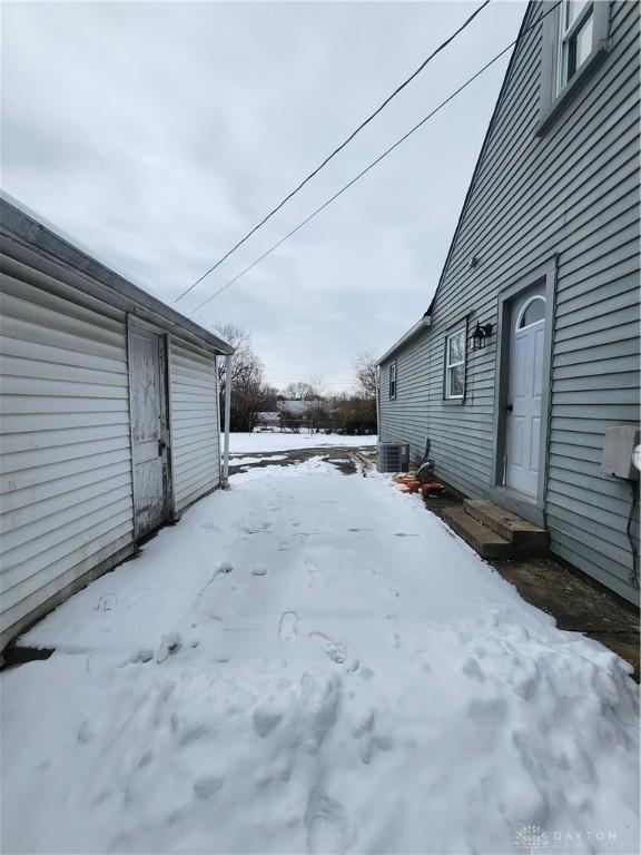 yard covered in snow featuring cooling unit