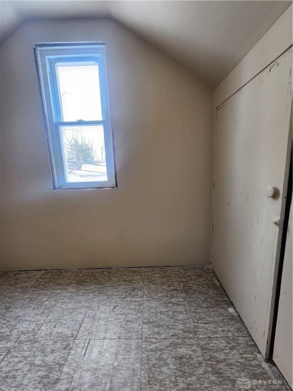 additional living space featuring vaulted ceiling