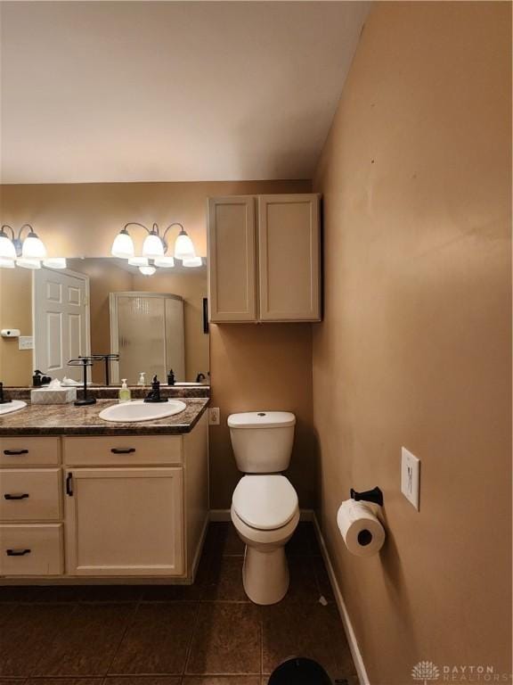 full bath featuring toilet, tile patterned flooring, baseboards, and vanity