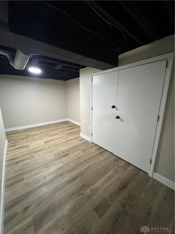 finished basement with baseboards and wood finished floors