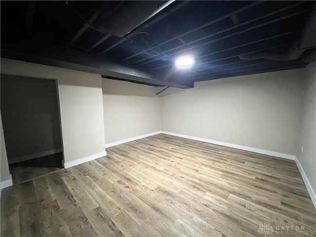 finished basement featuring baseboards and wood finished floors