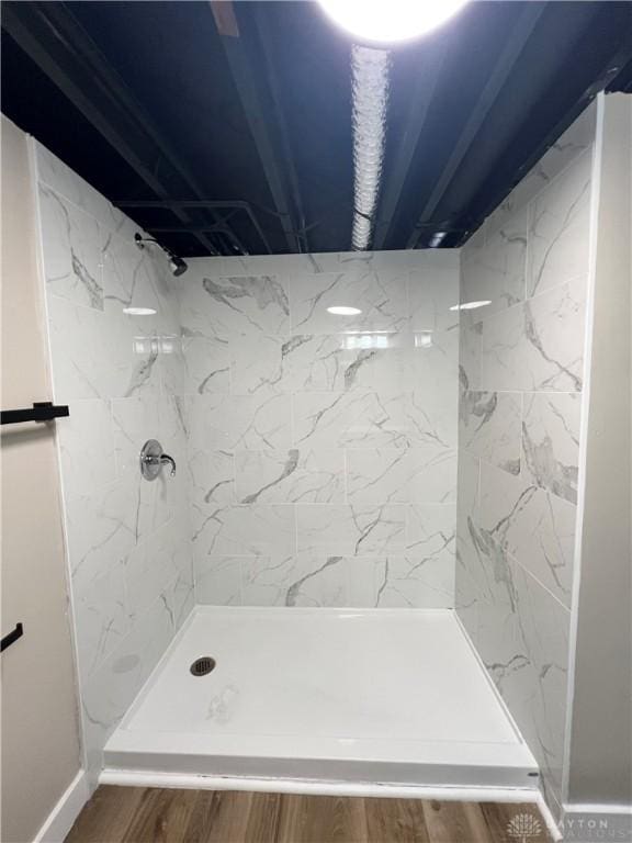 bathroom featuring a walk in shower and wood finished floors