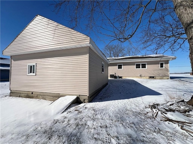 view of snow covered rear of property