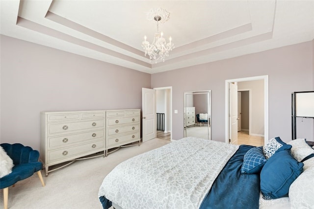 bedroom with light carpet, an inviting chandelier, and a raised ceiling