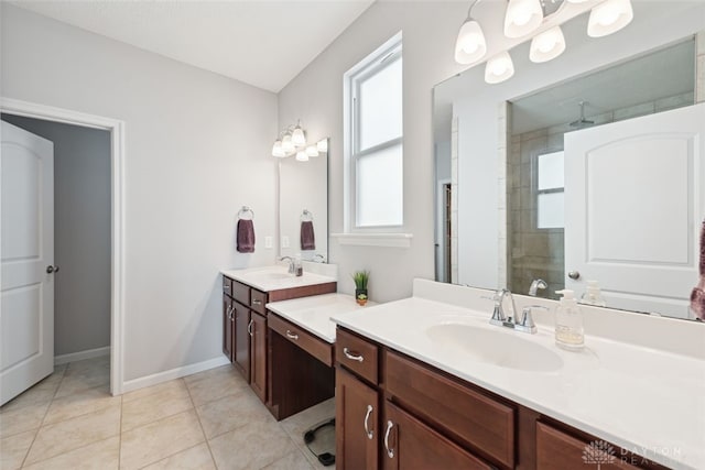 bathroom with tile patterned flooring, a shower stall, two vanities, and a sink