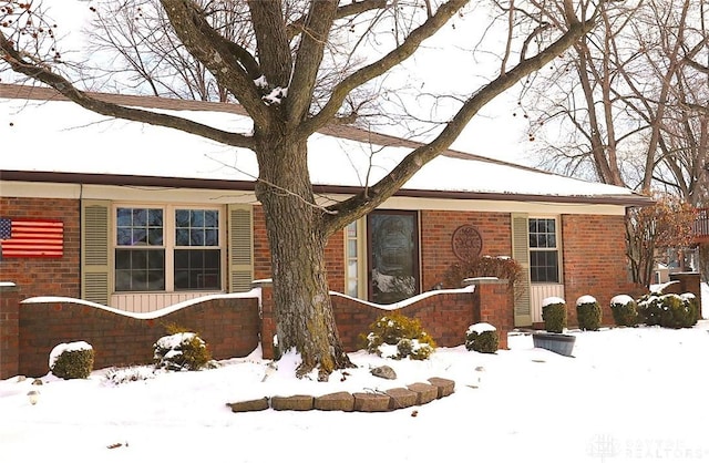 single story home featuring brick siding