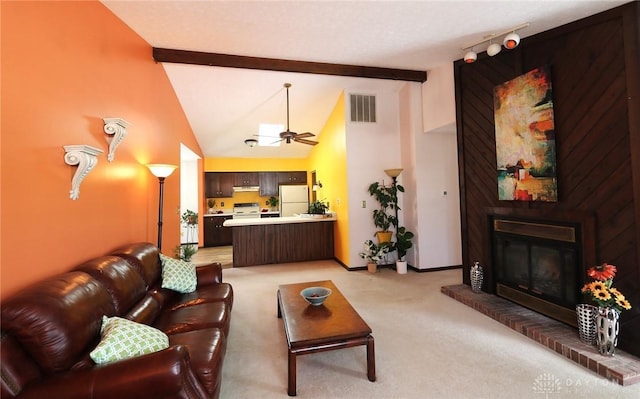 living room featuring beam ceiling, visible vents, a ceiling fan, a brick fireplace, and baseboards