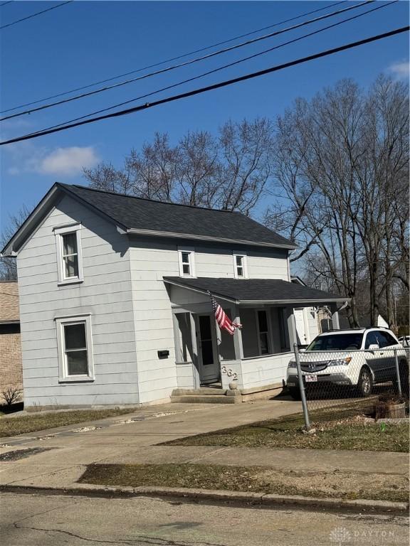 view of front of house with entry steps and a shingled roof